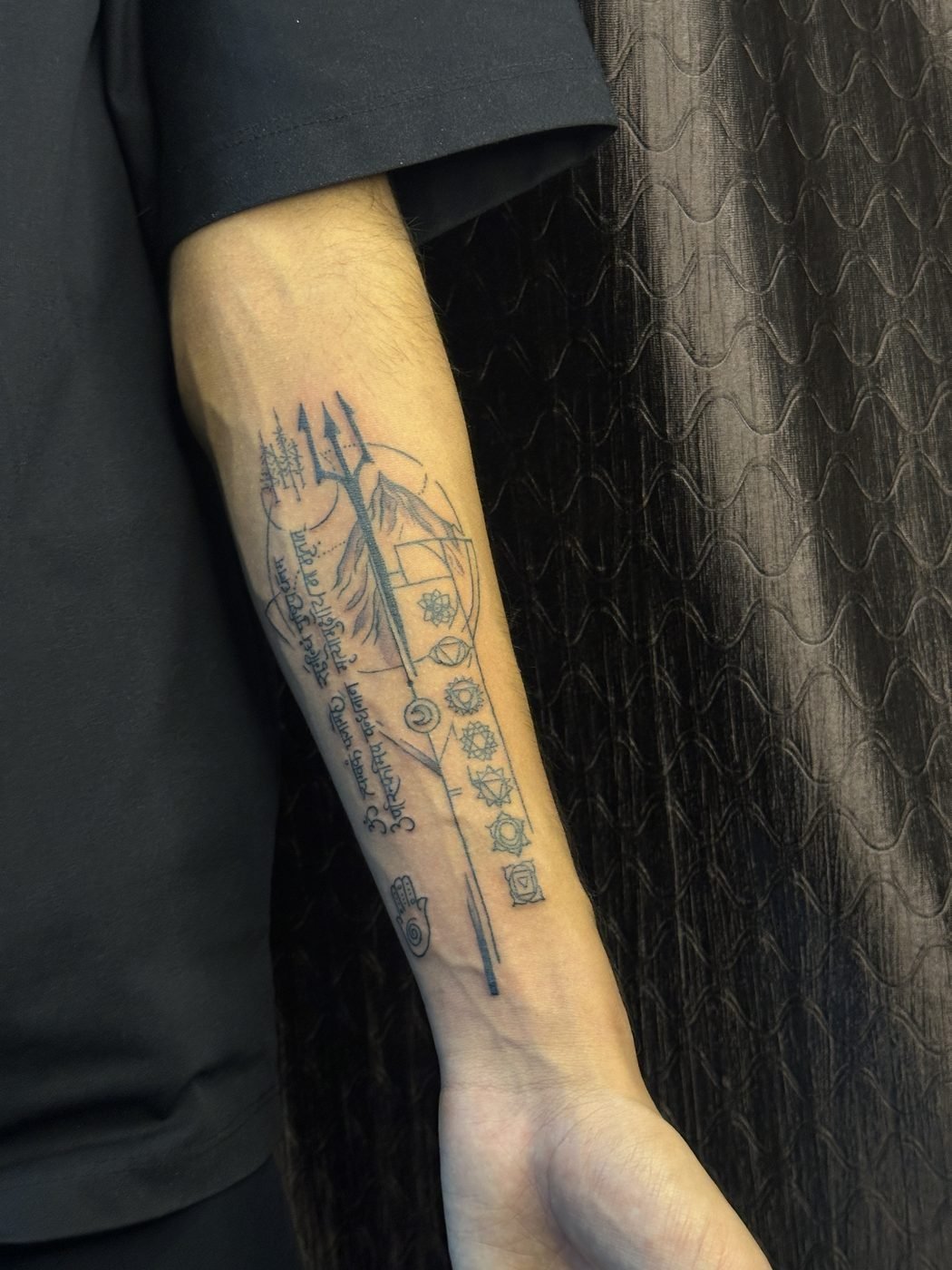 Alchemical symbols and trident fine line forearm tattoo