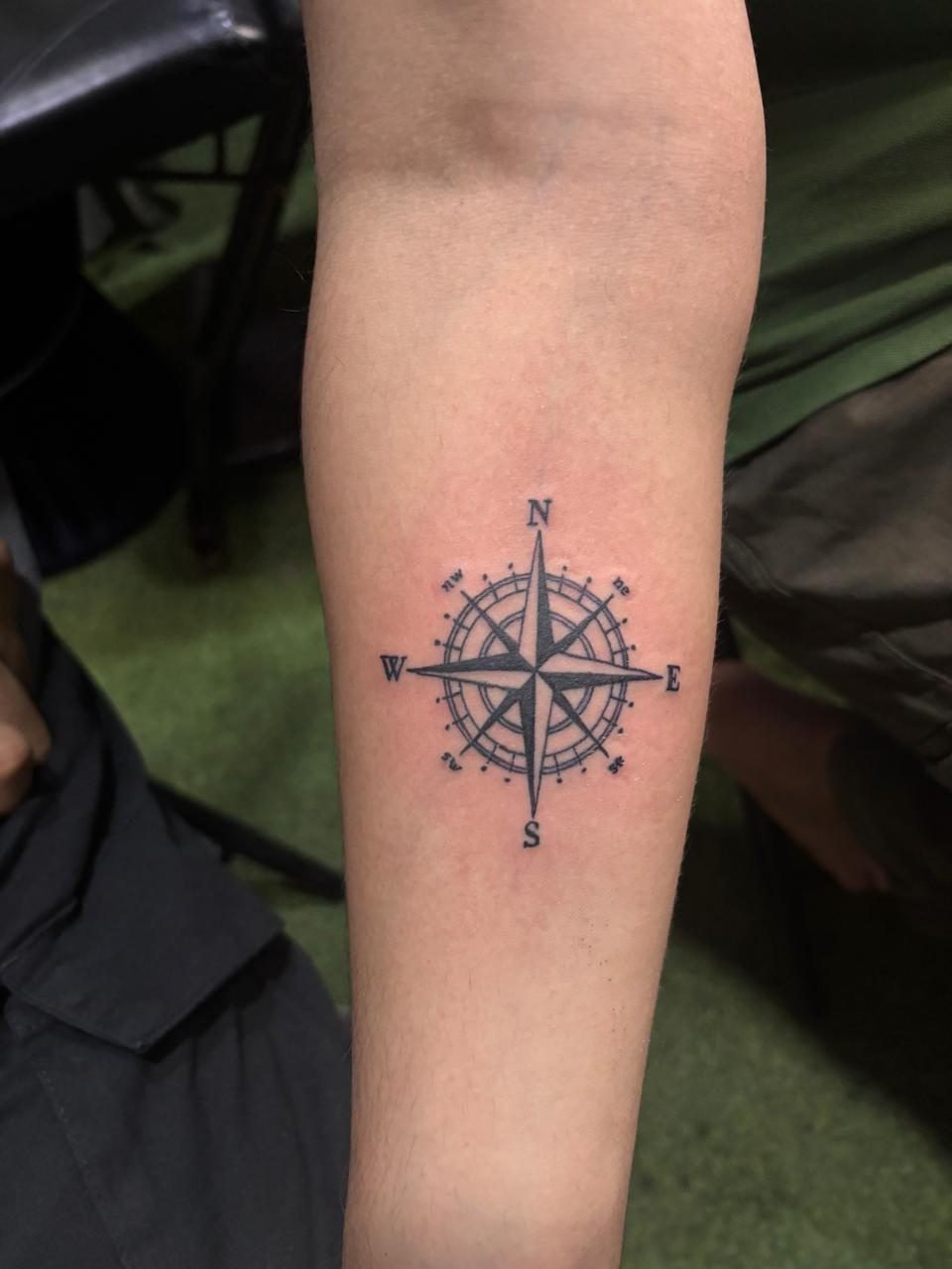 Minimalist compass tattoo