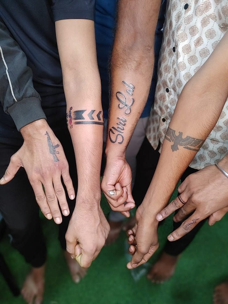 Friends showing off matching and custom tattoos