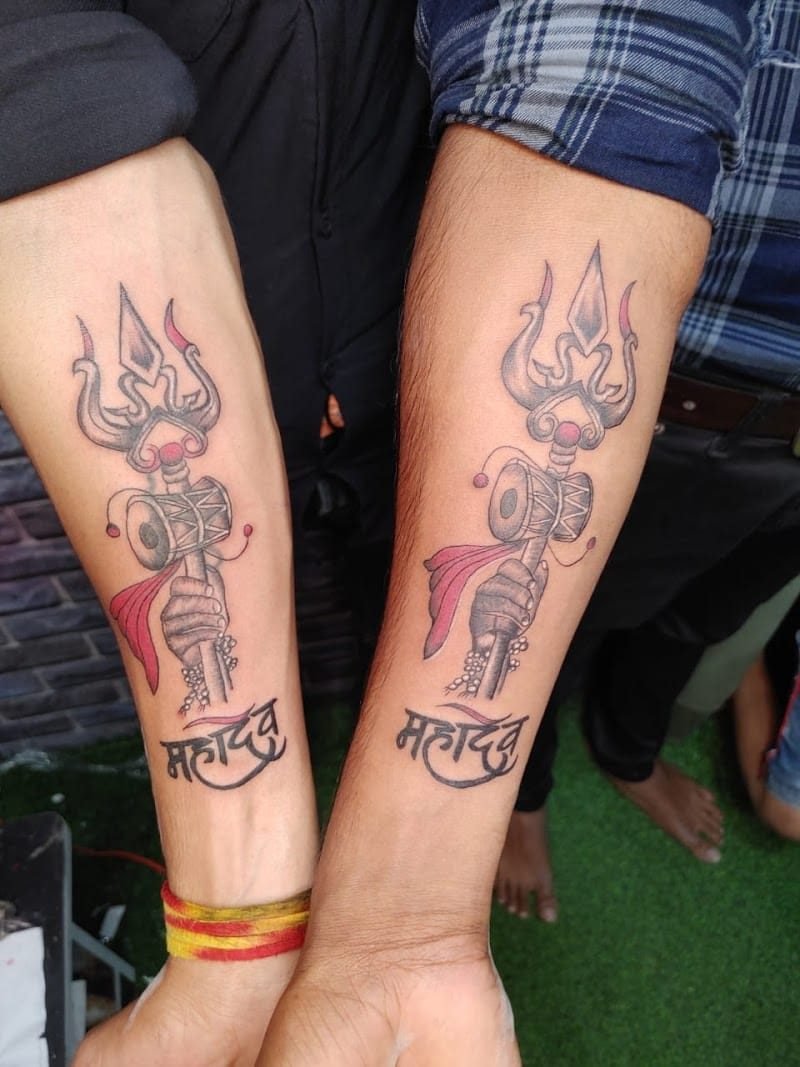 Matching Mahadev trishul and damaru tattoos