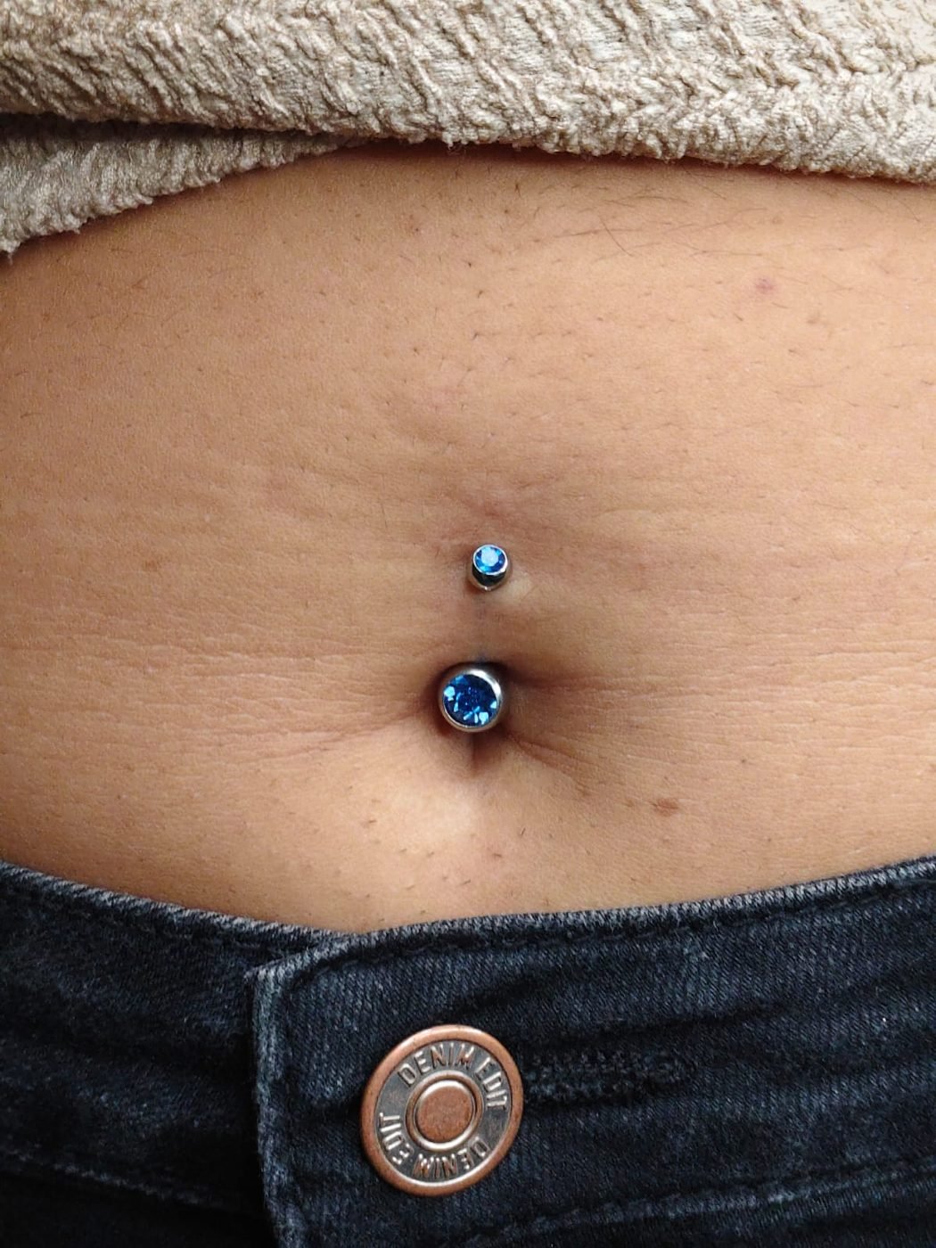 Navel piercing with blue gem jewellery